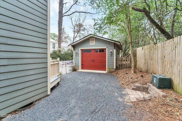 detached garage with driveway and fence