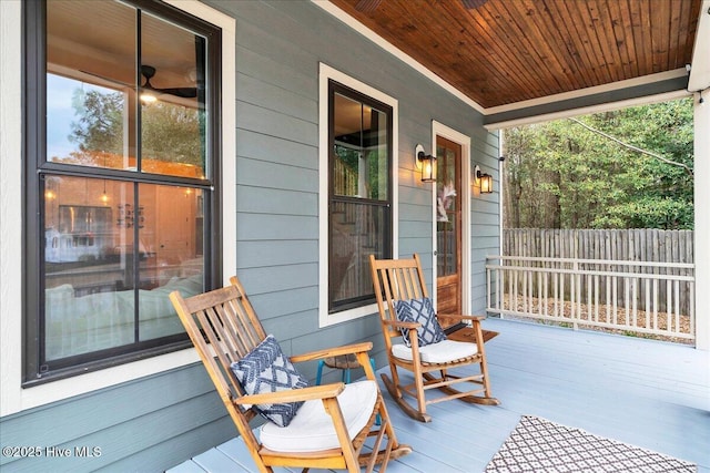 view of patio featuring a porch and fence