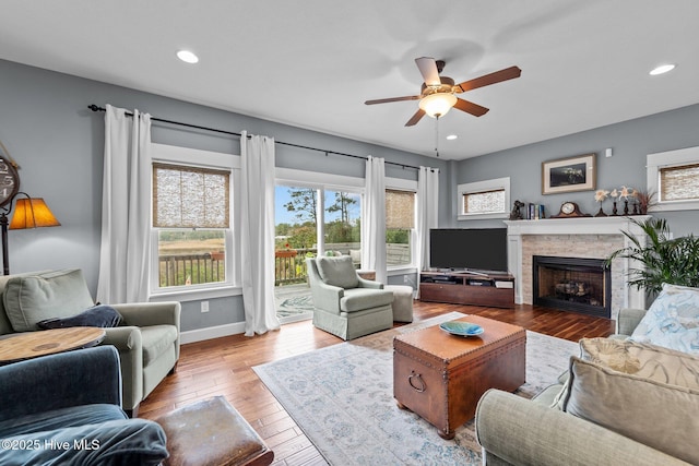 living room featuring ceiling fan and light hardwood / wood-style flooring