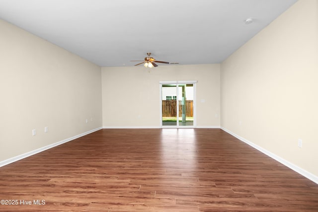 unfurnished room with baseboards, ceiling fan, and wood finished floors