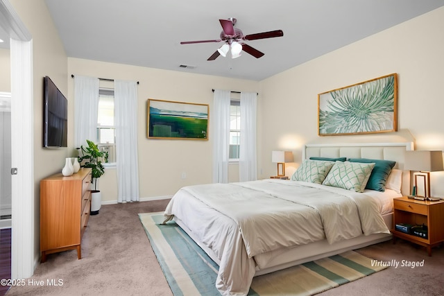 bedroom featuring baseboards, multiple windows, carpet, and visible vents