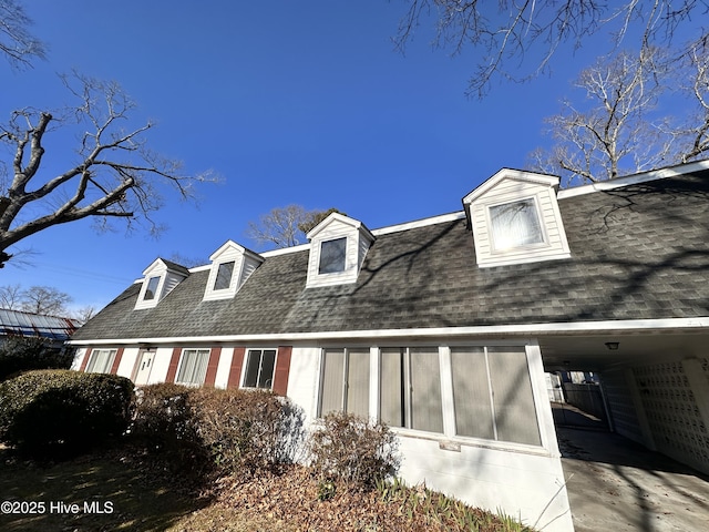 view of property exterior with a carport