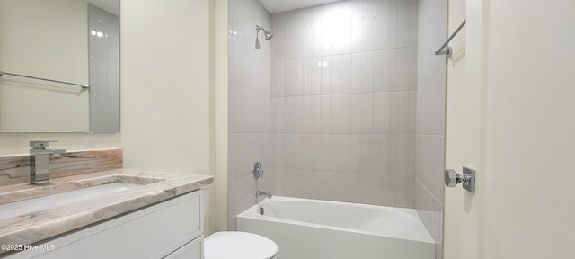 full bathroom featuring vanity, toilet, and tiled shower / bath combo