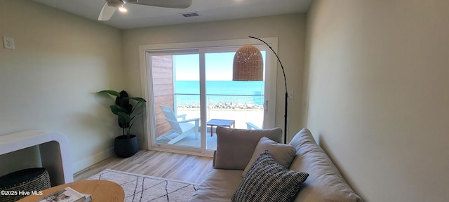 entryway featuring ceiling fan, a water view, and light wood-type flooring