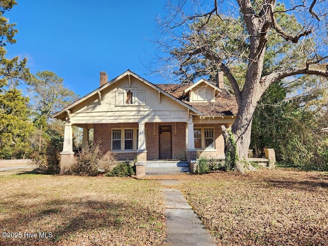 craftsman-style house with a porch and a front yard