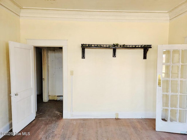 empty room with crown molding and hardwood / wood-style flooring