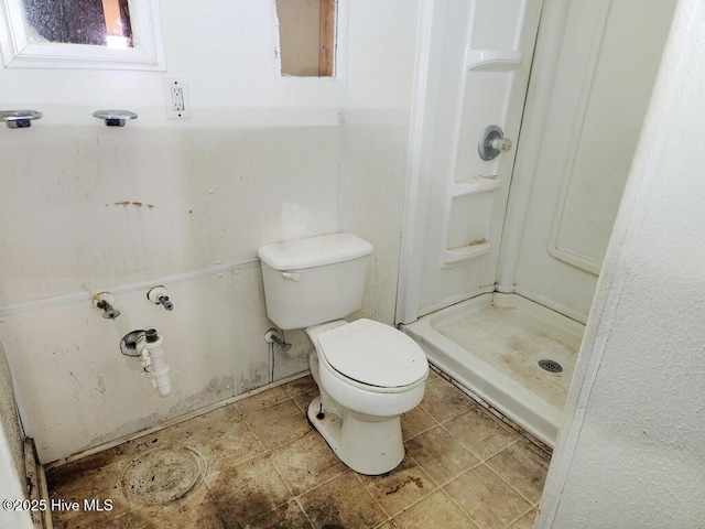 bathroom with walk in shower and toilet