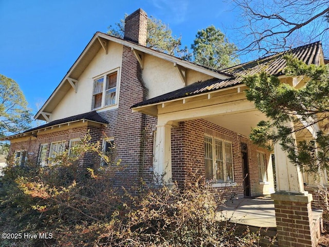 view of side of home featuring a porch