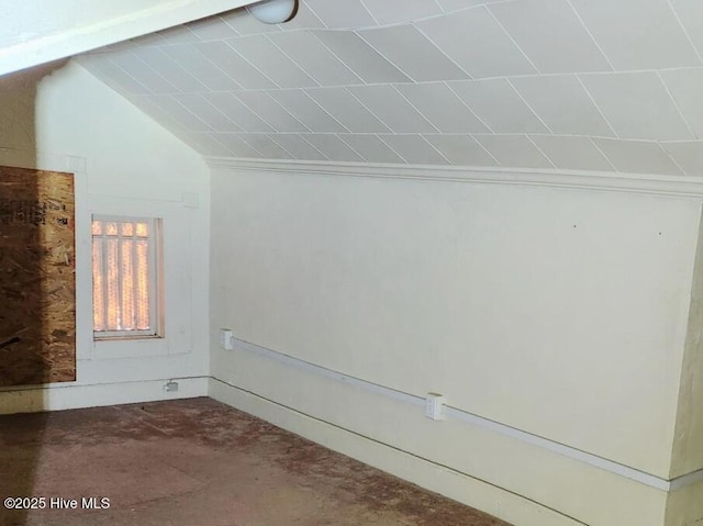 additional living space with carpet floors and vaulted ceiling