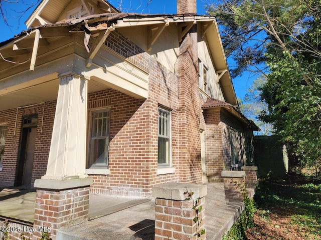 view of side of property with a porch