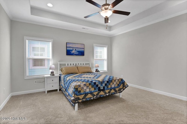 bedroom featuring crown molding, a raised ceiling, and carpet flooring