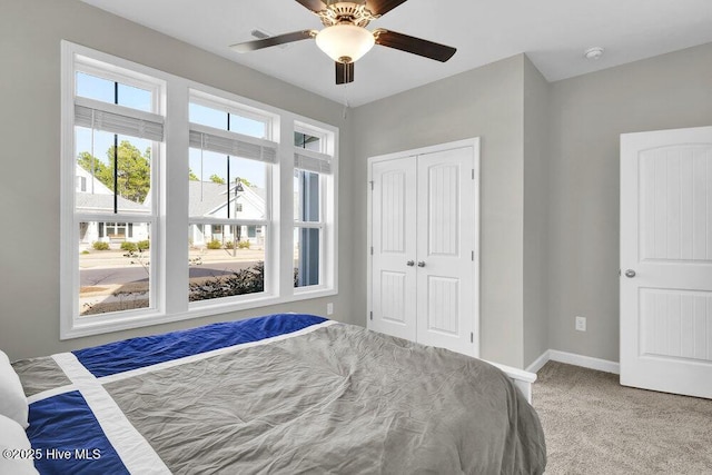 unfurnished bedroom featuring ceiling fan, a closet, and carpet