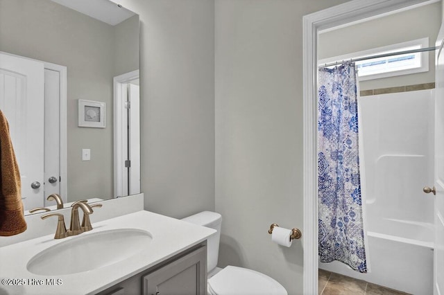 full bathroom featuring vanity, tile patterned floors, toilet, and shower / tub combo with curtain