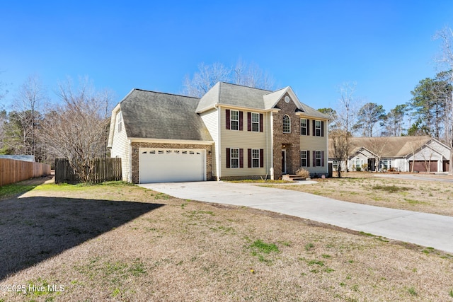 colonial house featuring driveway, a garage, brick siding, fence, and a front yard