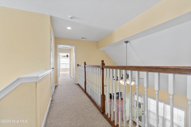 hall featuring light carpet, visible vents, and recessed lighting