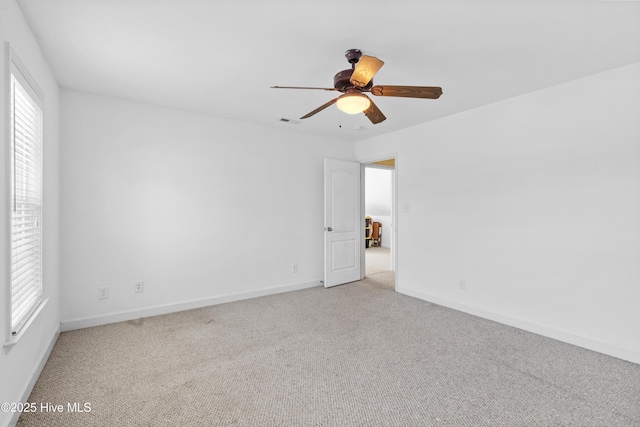 unfurnished room featuring ceiling fan, carpet flooring, visible vents, and baseboards