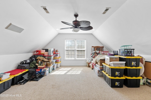 recreation room featuring carpet, visible vents, and vaulted ceiling