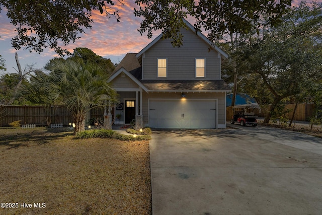 view of front of house with a garage and a yard