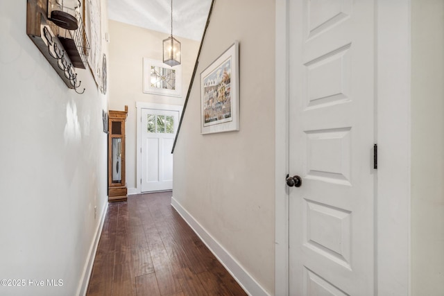 corridor with dark hardwood / wood-style flooring