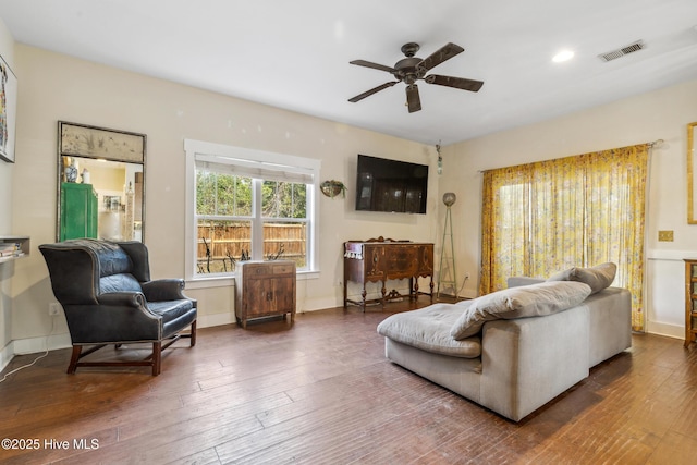 living room with dark hardwood / wood-style floors and ceiling fan