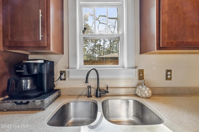 kitchen featuring light stone countertops and sink