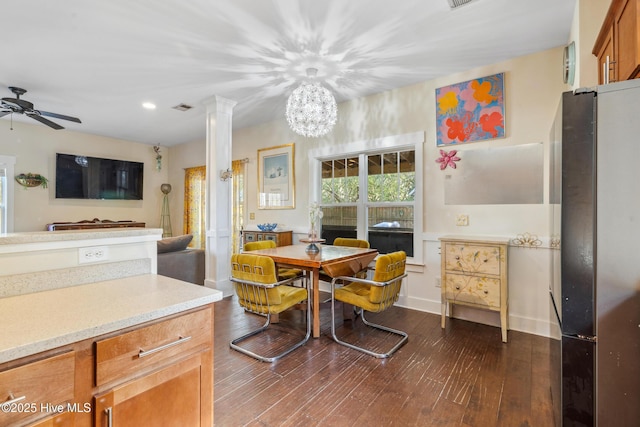 dining space featuring dark hardwood / wood-style flooring, decorative columns, and ceiling fan