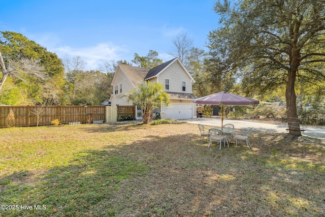 view of property exterior featuring a garage and a yard