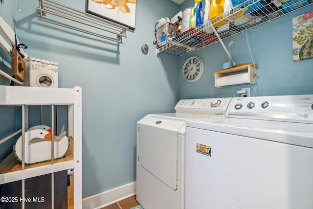 clothes washing area featuring separate washer and dryer