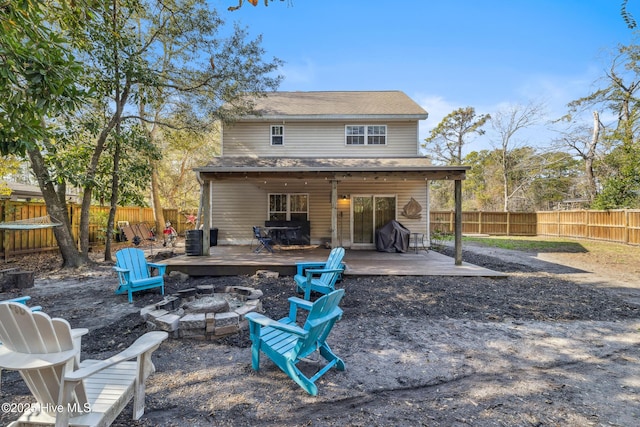 back of property with a patio area and a fire pit