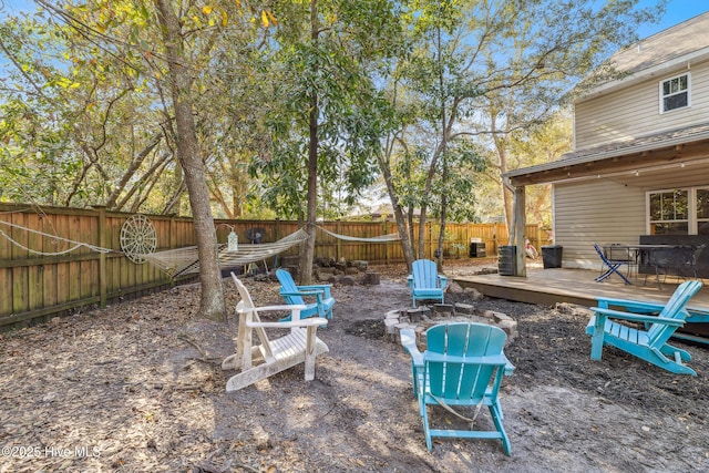 view of patio with a wooden deck and a fire pit