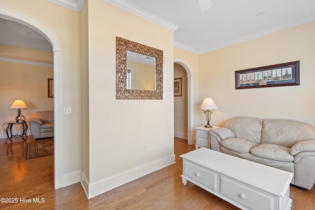 living room with ornamental molding and light hardwood / wood-style floors