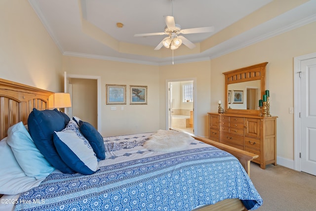 bedroom with ceiling fan, connected bathroom, ornamental molding, light carpet, and a raised ceiling