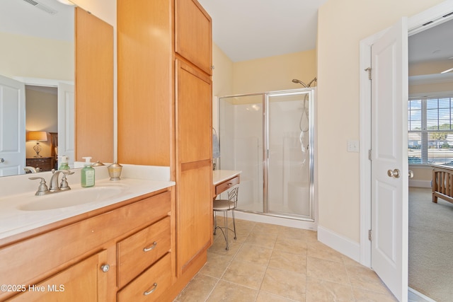 bathroom featuring an enclosed shower, vanity, and tile patterned flooring