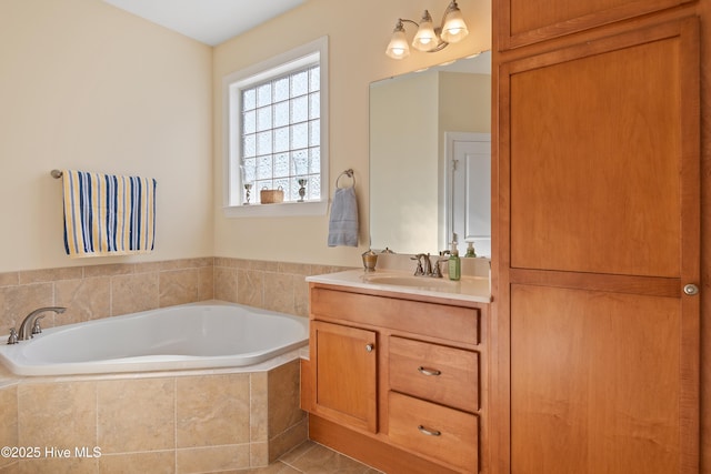 bathroom featuring vanity, tiled bath, and tile patterned flooring