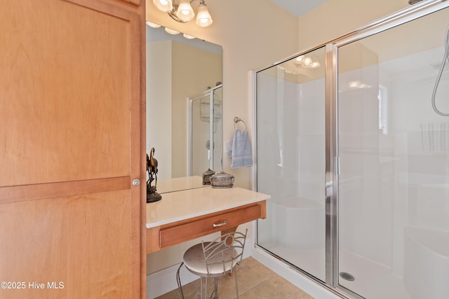 bathroom with an enclosed shower and tile patterned floors