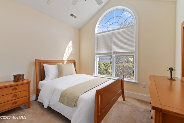 bedroom with light carpet, vaulted ceiling, and ceiling fan