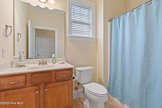 bathroom with tile patterned flooring, vanity, a shower with shower curtain, and toilet