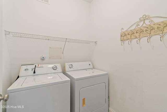 washroom with washing machine and clothes dryer