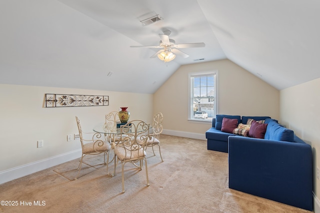 dining space featuring vaulted ceiling, light colored carpet, and ceiling fan