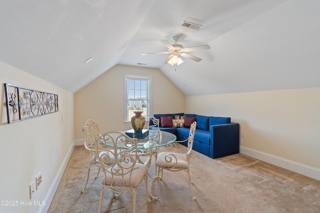 dining room featuring ceiling fan, light colored carpet, and lofted ceiling