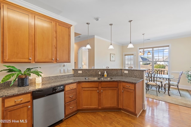 kitchen with dark stone countertops, sink, hanging light fixtures, and dishwasher