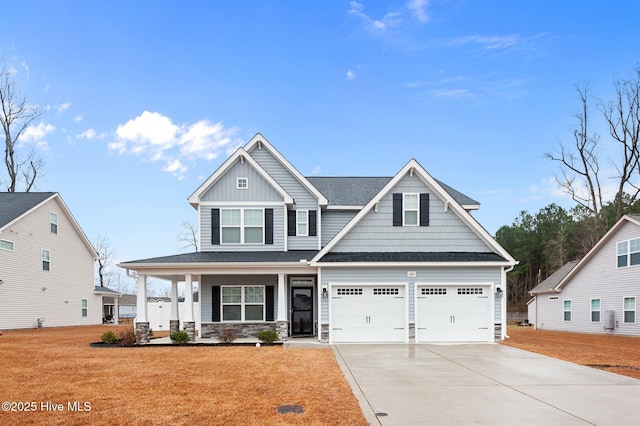 craftsman-style house with a garage, a front yard, and covered porch