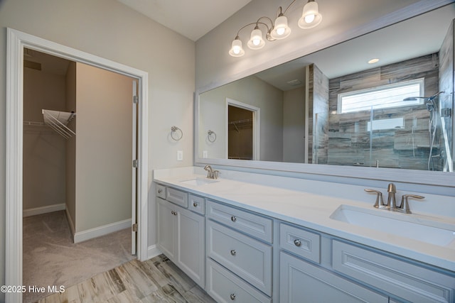 bathroom featuring vanity and an enclosed shower