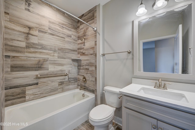 full bathroom with vanity, tiled shower / bath, and toilet