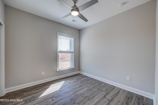 empty room with ceiling fan and dark hardwood / wood-style floors