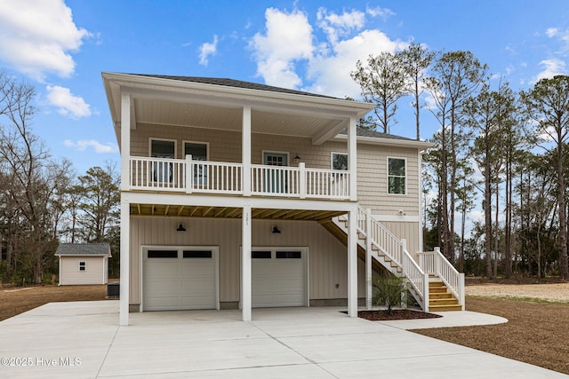 coastal home with a garage and a porch