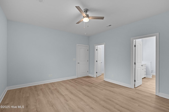 unfurnished bedroom with ensuite bathroom and light wood-type flooring