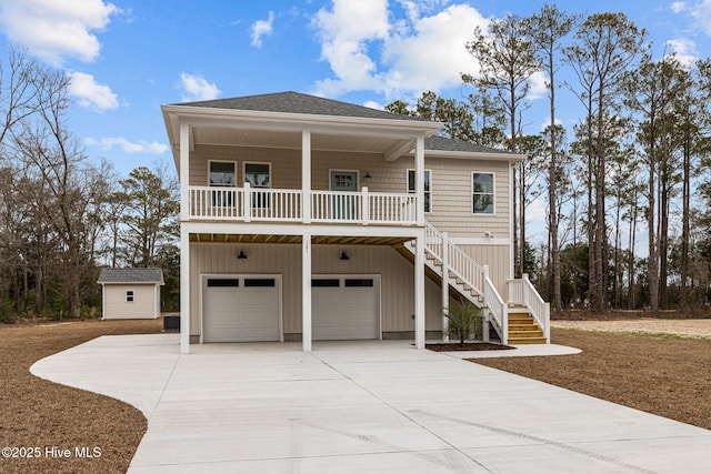 coastal home featuring a garage and covered porch