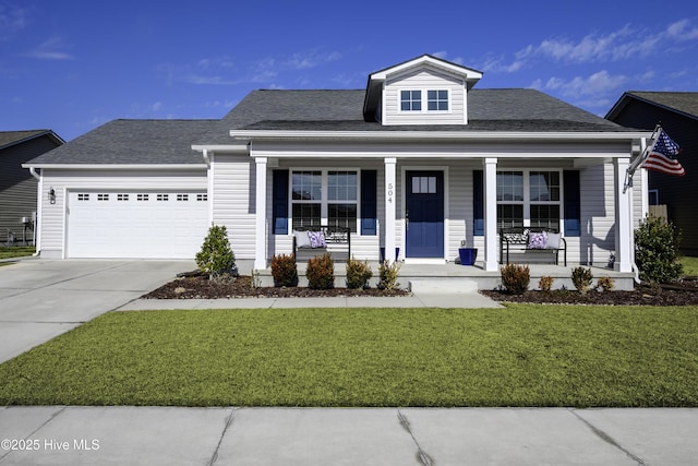 view of front of home featuring a porch, a garage, and a front lawn