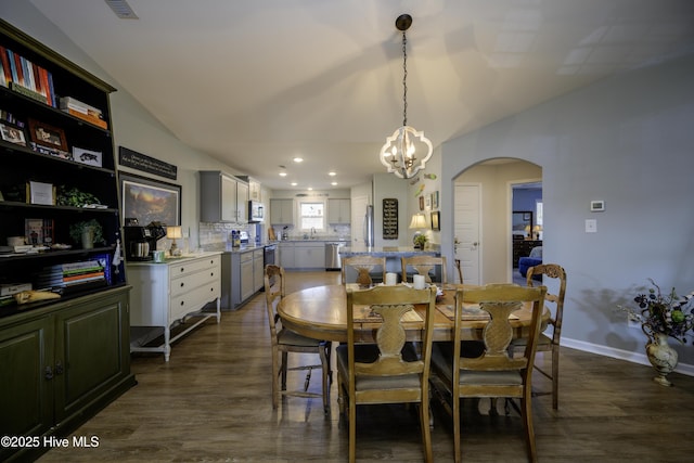 dining room featuring an inviting chandelier and dark hardwood / wood-style floors